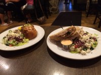 Crab cake sandwich on left. To its right is grilled chicken panini.