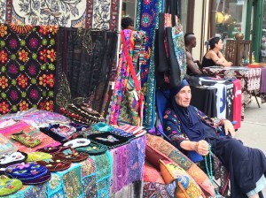 Lady in blue with her colorful wares.