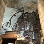 High Wheeler bicycles "floating" above a stagecoach.